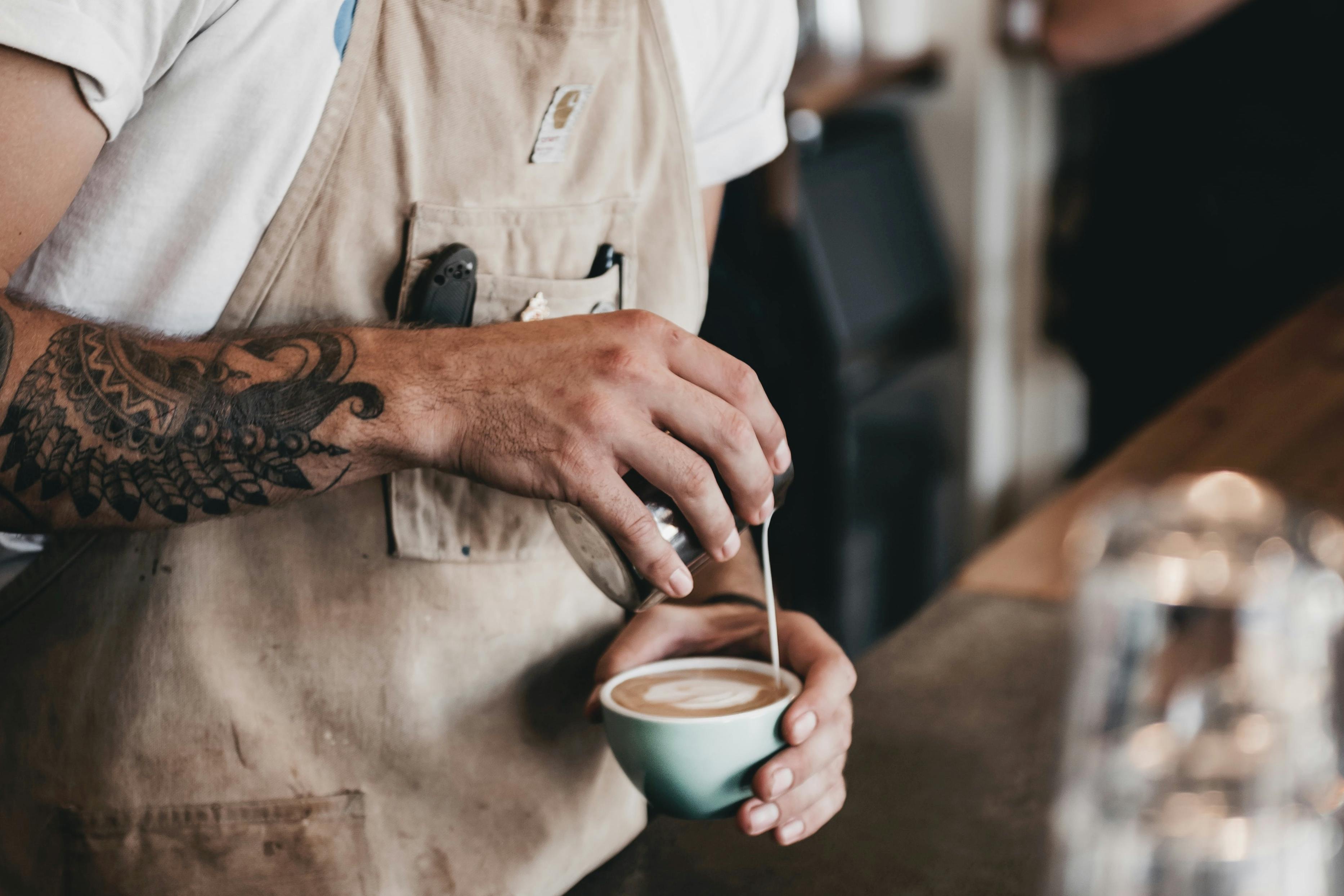A barista brews a perfect coffee in a cafe.
